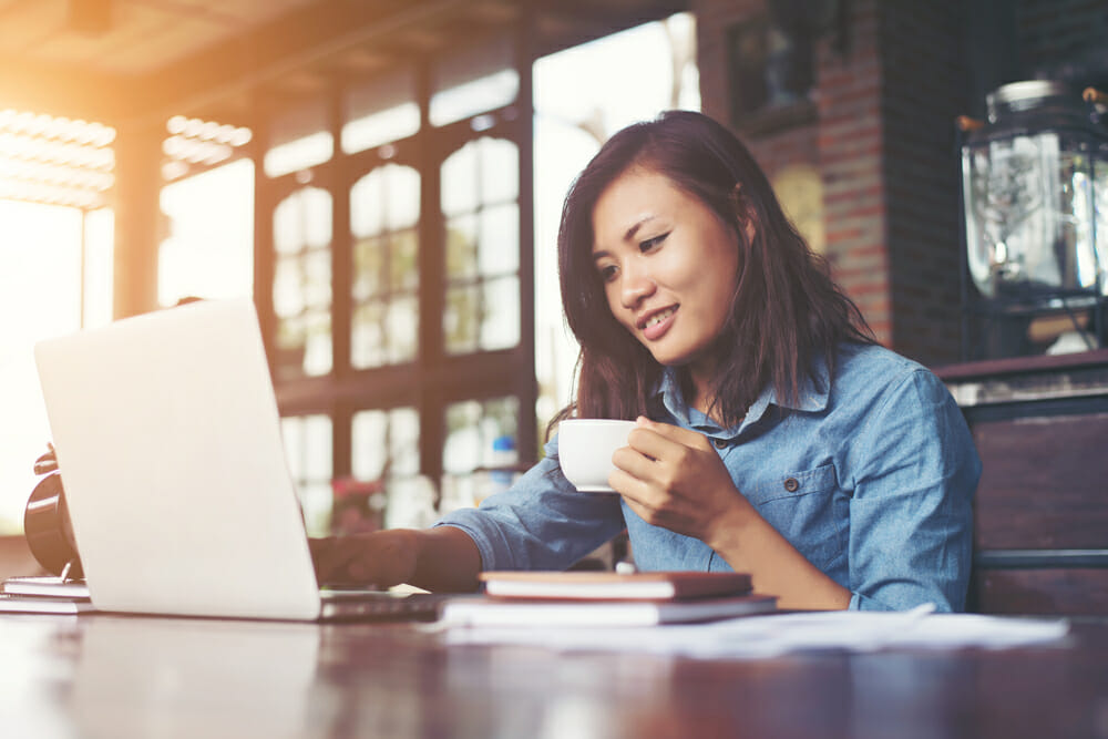 Woman on a laptop drinking coffee